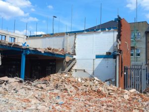 Partly demolished building with rubble