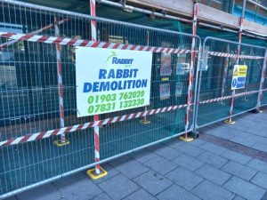 Rabbit Demolition company banner at demolition site